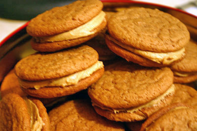 Molasses sandwich cookies in a tin.