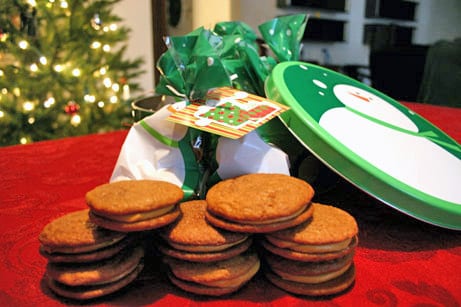 Molasses sandwich cookies with holiday decorations behind them