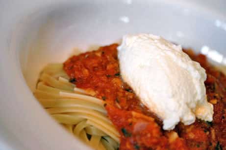 Plate of linguine with tomato sauce and ricotta cheese.