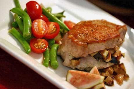 Stuffed pork chops with bean and tomato salad alongside.