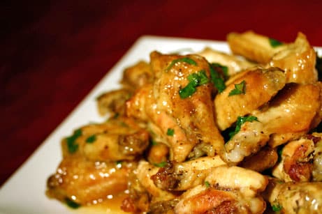 Curry-lime chicken wings topped with cilanrto.