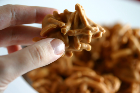 Hand holding a peanut butter haystack.