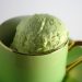 Green coffee cup filled with avocado ice cream.