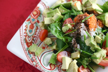 Baby spinach salad with avocado and tomato.