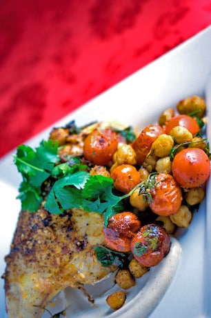 Roast chicken breast with chickpeas and tomatoes.