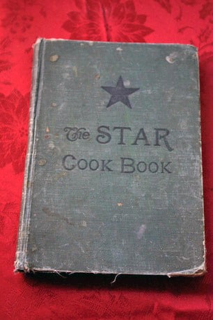 Overhead view of an old book with text that says, \"The Star Cook Book\".