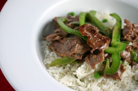 Beef and bell pepper stir-fry over rice.