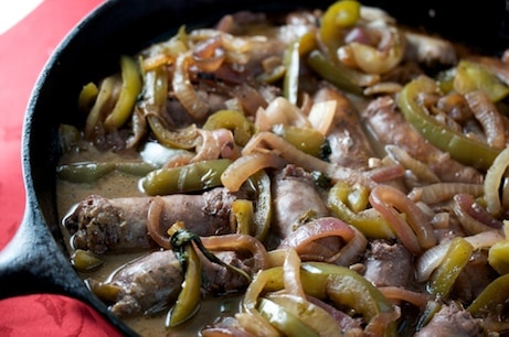 Sausage and peppers in a skillet.