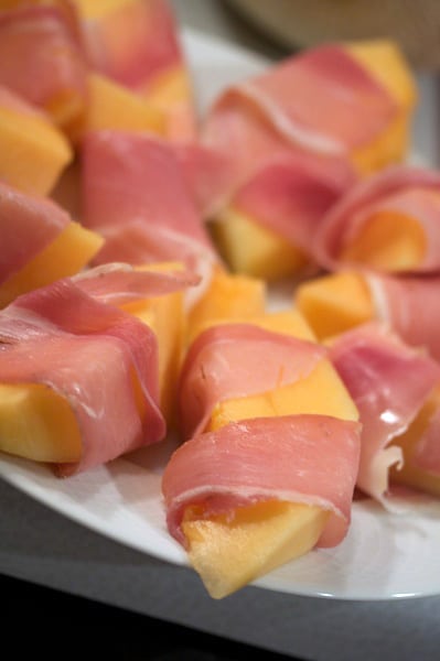 Cantaloupe wrapped with prosciutto.