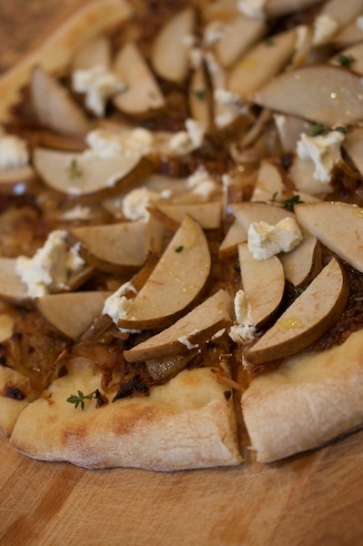 Pizza topped with caramelized onions, pear, and goat cheese.