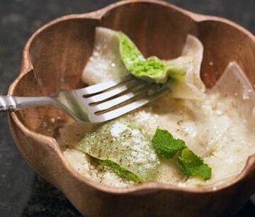 Ravioli filled with peas and parmesan in a bowl.