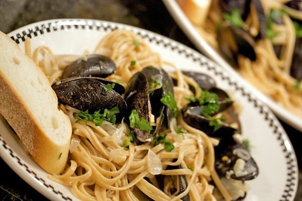 Plate of mussels over linguine.