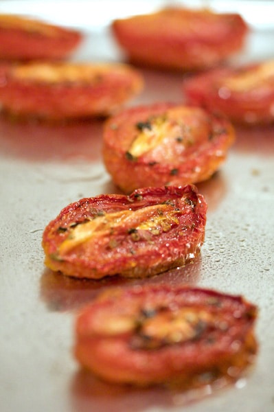 Oven-roasted tomatoes on a baking sheet.