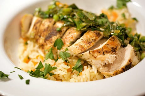 Sliced chicken over rice.