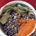 Whole spices in a spice grinder.