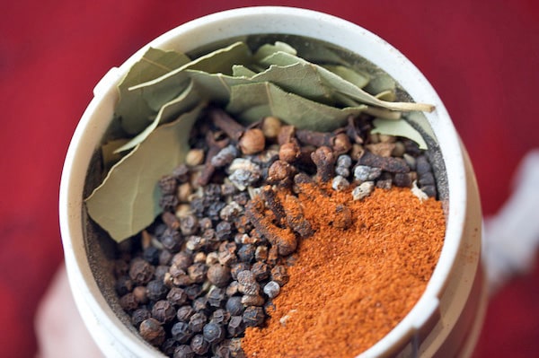 Whole spices in a spice grinder.