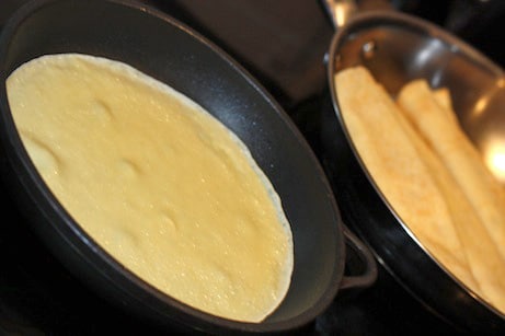 Crepes cooking on the stovetop.