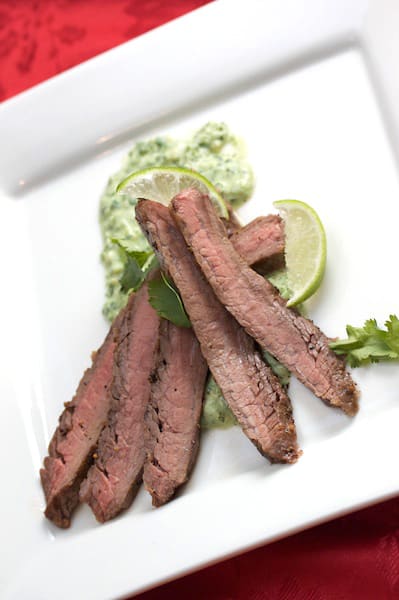 Sliced flank steak with cilantro pesto.