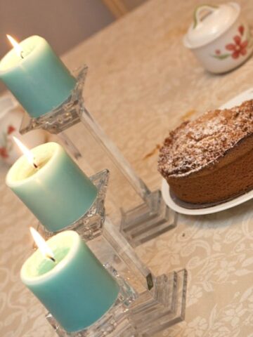Cake on a table with candlesticks.