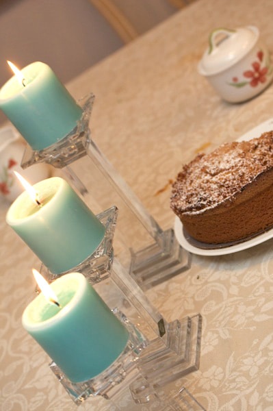 Cake on a table with candlesticks.