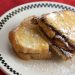 Grilled Nutella and banana sandwich with powdered sugar.