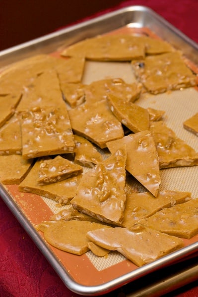 Walnut brittle on a baking sheet.