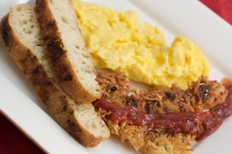 Eggs, toast, and hashbrowns on a plate.