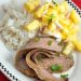 A plate of sliced flank steak with pineapple salsa and rice.