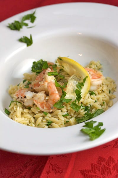 Bowl of shrimp over orzo.