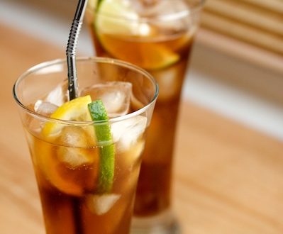 Glasses of Texas tea with lemon and lime wedges.