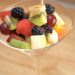 Martini glass filled with fruit salad.