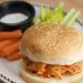 Buffalo chicken sandwich with carrots, celery, and blue cheese dip.