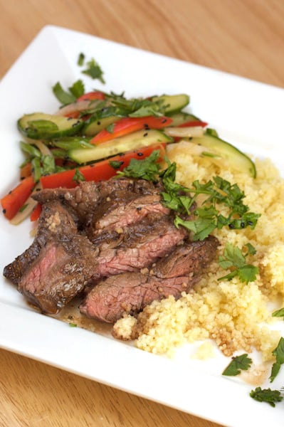 Plate of grilled skirt steak with couscous and vegetables.