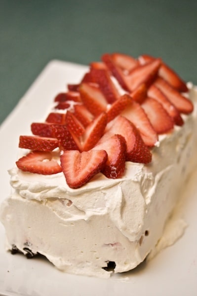 Ice cream cake topped with strawberries.