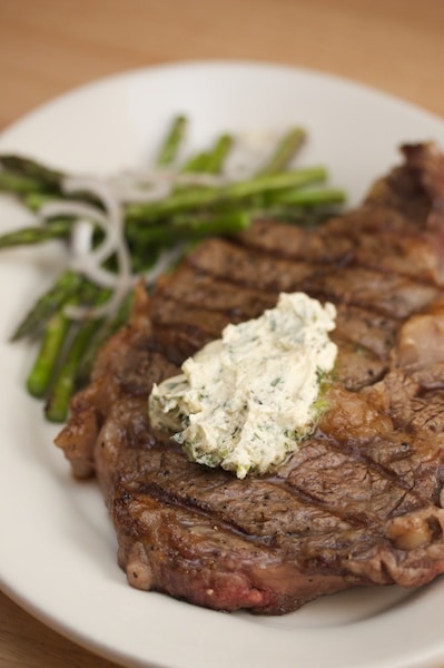 Grilled steak topped with compound butter.