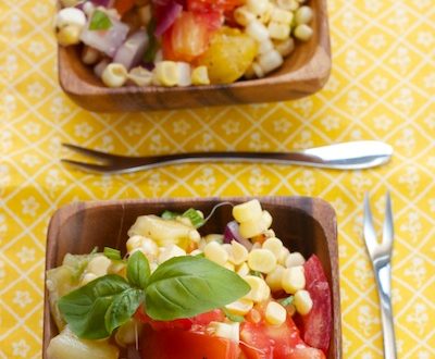 Small bowls of tomato-corn salad with fresh basil.