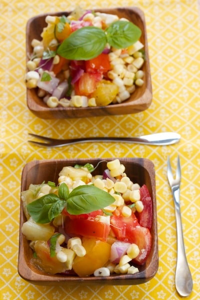 Small bowls of tomato-corn salad with fresh basil.