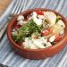 Bowl of Greek tomato cucumber salad with feta.