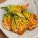 Ricotta stuffed zucchini blossoms on a plate.