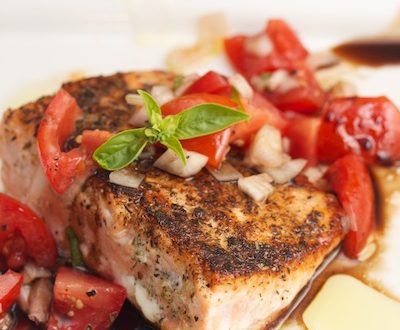 Seared salmon with tomato and basil.