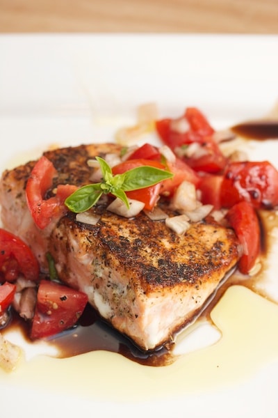 Seared salmon with tomato and basil.