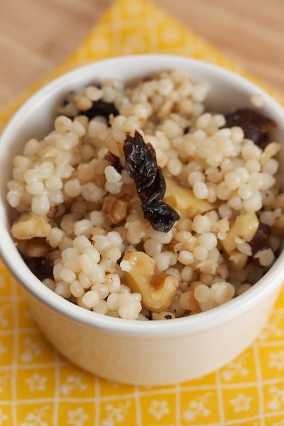 Ramekin of Israeli couscous with walnuts and dried plums.