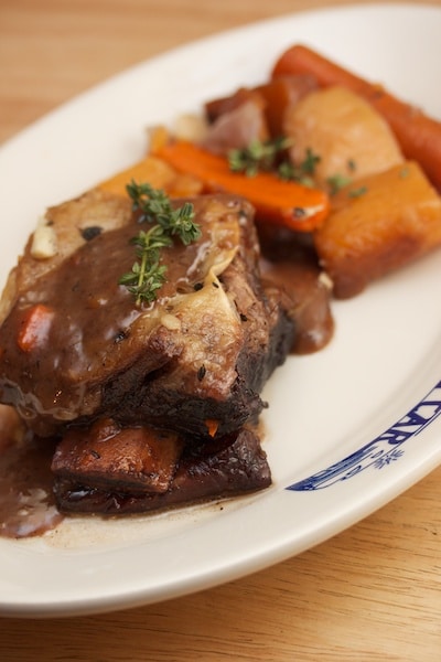 Short ribs with red wine sauce and root vegetables.