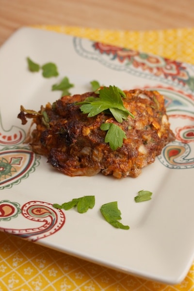 Piece of meatloaf on a plate with parsley.