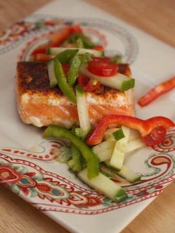 Salmon with raw veggies on top.