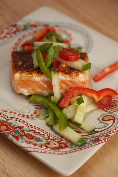 Salmon with raw veggies on top.