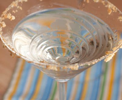 Martini in a glass with graham cracker rim.