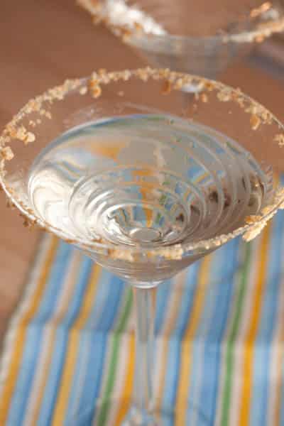 Martini in a glass with graham cracker rim.
