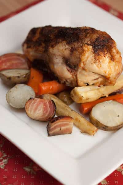 Roast chicken and root vegetables on a plate.