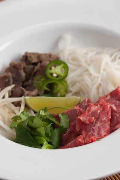 A bowl of beef pho ready for broth.